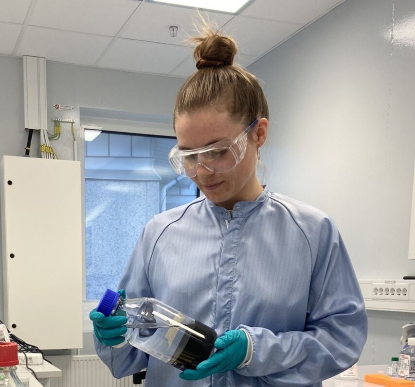 Mashup photo of a student looking at a molecular model and data around