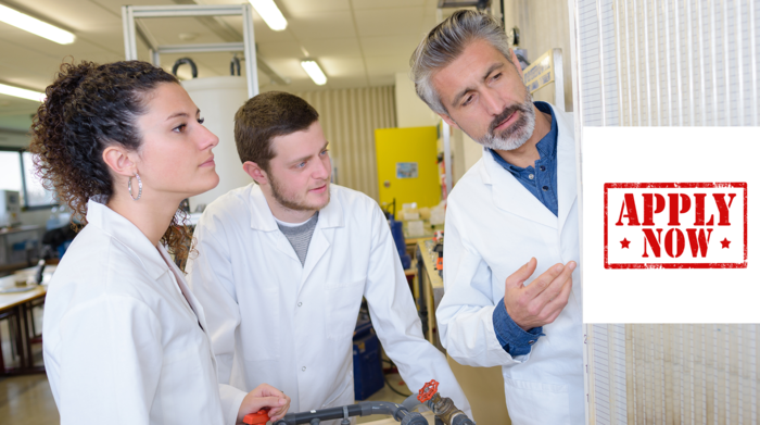 Two young students and a teacher in lab