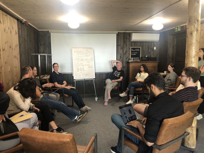 A picture of people discussing in a circle