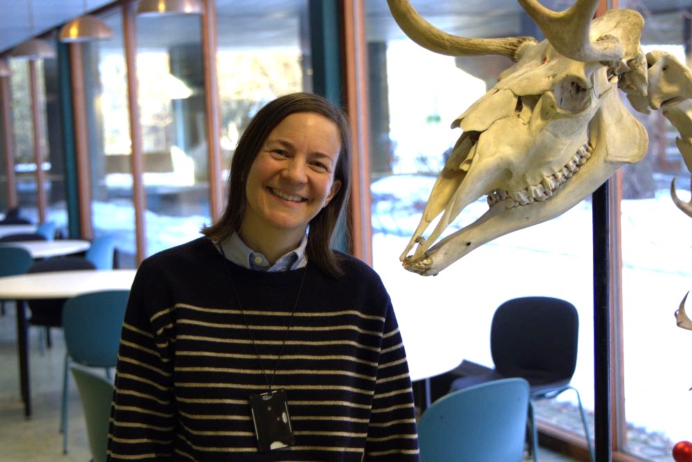 A picture of Ingrid Shields with a large deer skeleton