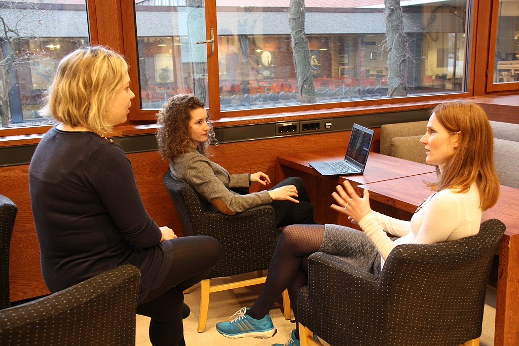  three ladies discussing sitting in chairs