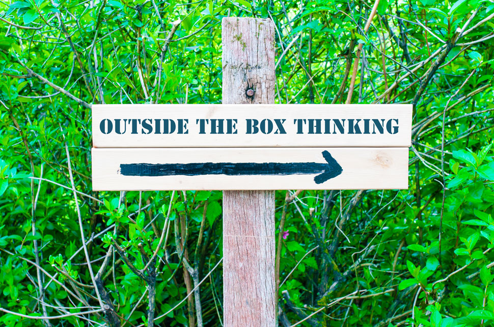 Sign with text "Outside the box thinking" and arrow